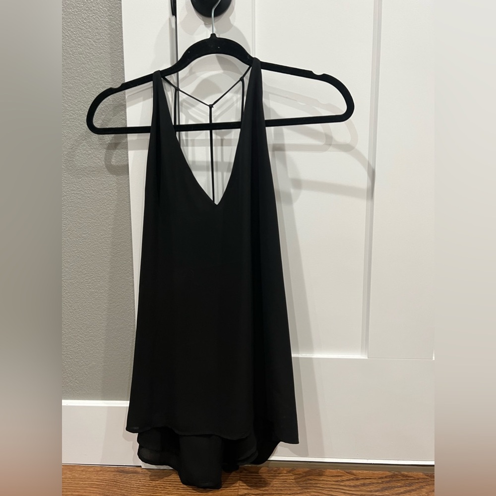 Never worn, criss cross back tank top.